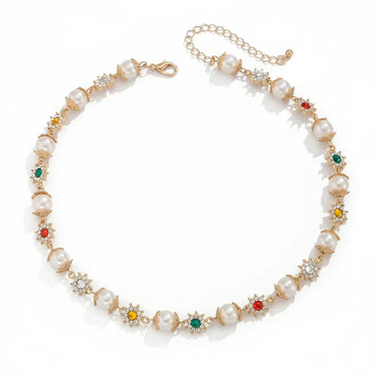 Elegant gold chain necklace with large faux pearls and multicolored gemstone flower accents