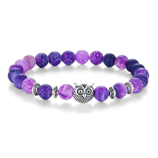 Purple agate bead bracelet with silver owl charm and decorative spacers on white background