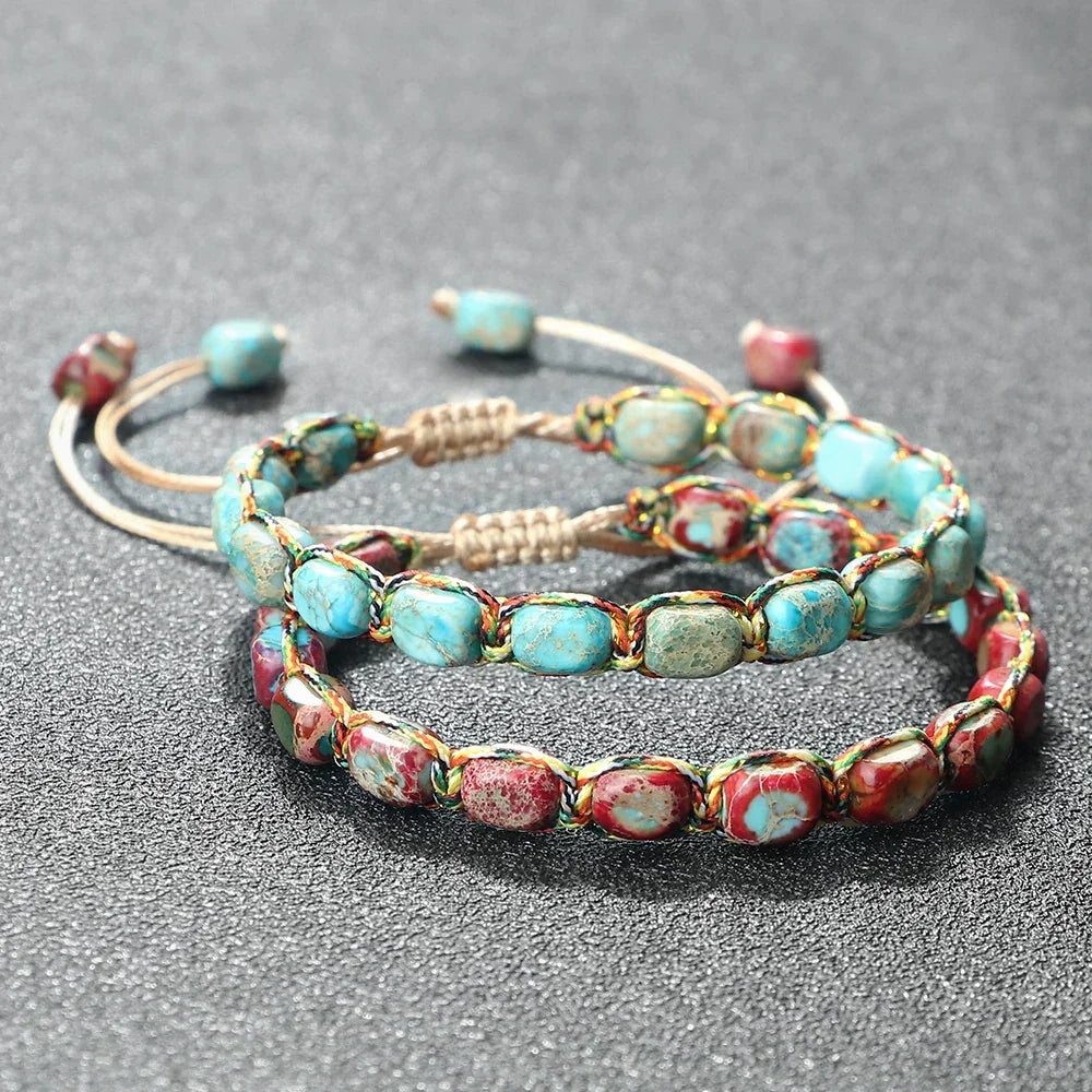 Handwoven adjustable bracelets with polished turquoise and red natural stone beads on gray surface