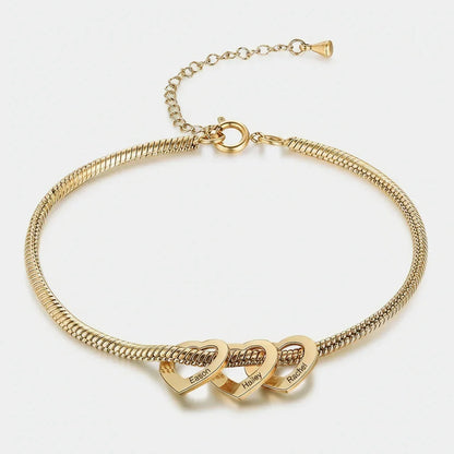 gold bracelet with three linked heart pendants engraved with names Eason, Hailey, and Rachel