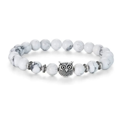 White marble bead bracelet with silver owl charm and decorative spacers on white background