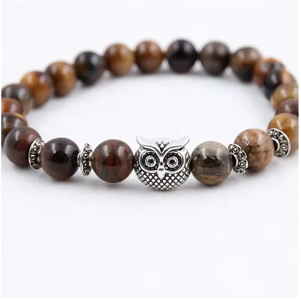 Beaded bracelet with brown tiger eye stones and a silver owl charm centerpiece