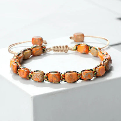 Adjustable bracelet with orange and beige natural stone beads on woven cord