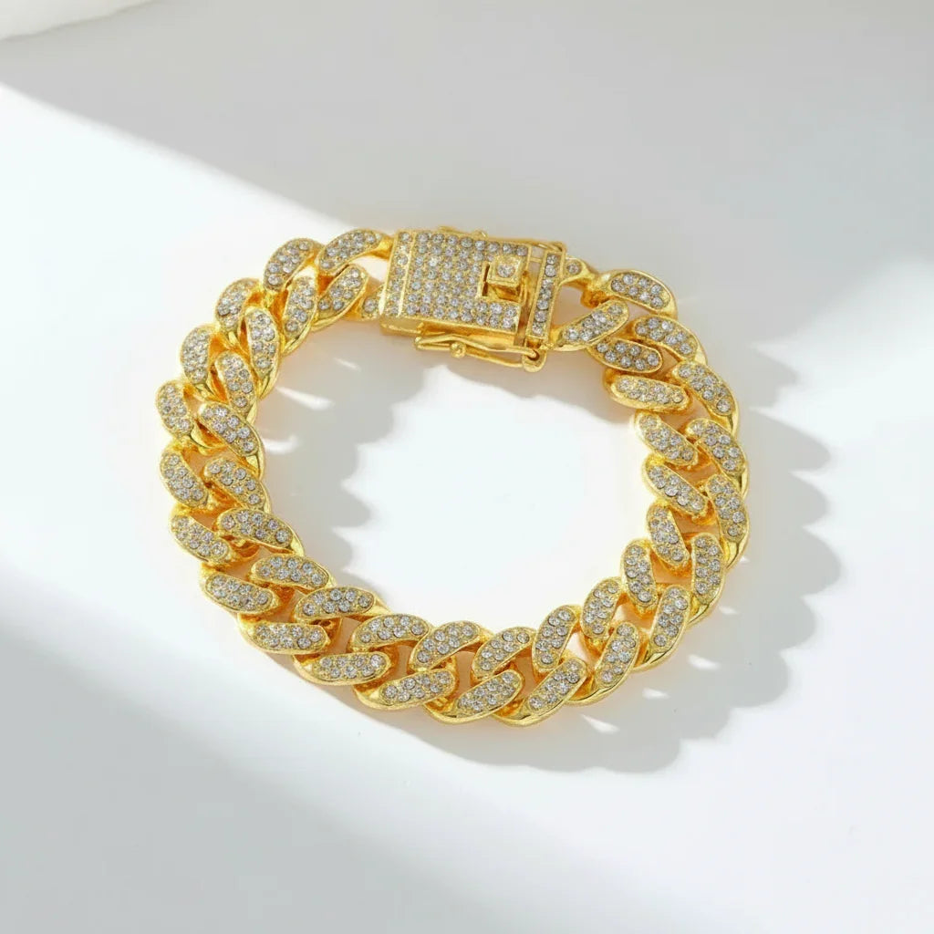 Gold Cuban link bracelet encrusted with sparkling diamonds on white surface